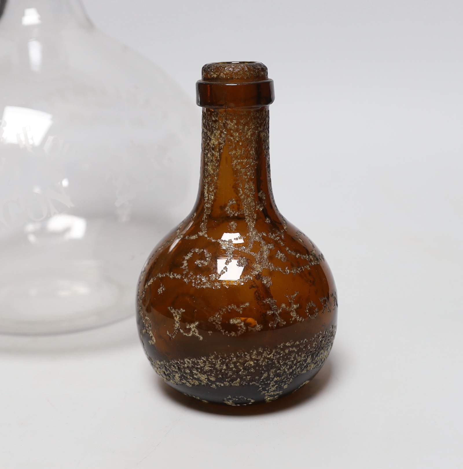 A large engraved, “Max Greger & Co London Wine Flagon”, a small amber glass bottle 1891 and a figural wax sculpture under dome, tallest flagon 26cm high